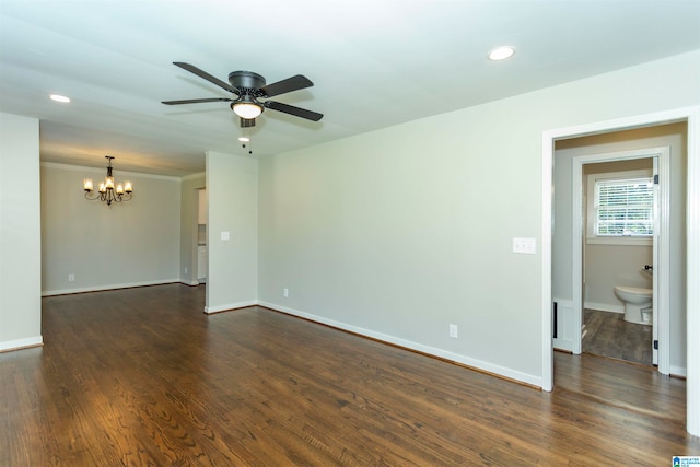 spare room with ceiling fan with notable chandelier, crown molding, and dark hardwood / wood-style flooring