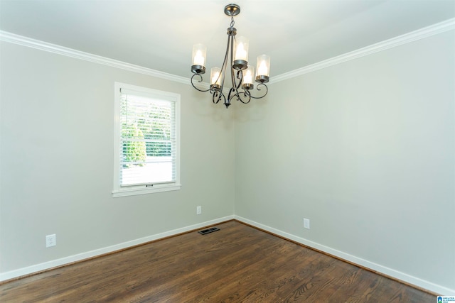 unfurnished room with ornamental molding, an inviting chandelier, and dark hardwood / wood-style flooring