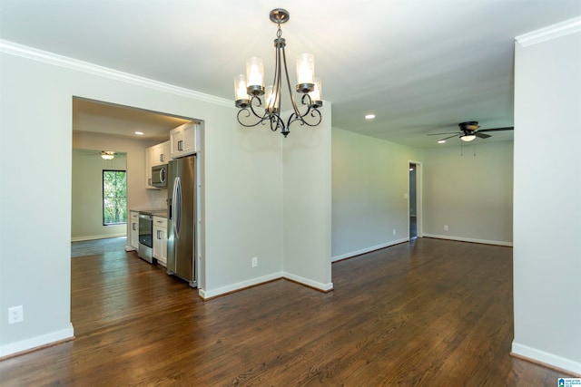 empty room with ceiling fan with notable chandelier, dark hardwood / wood-style floors, and crown molding