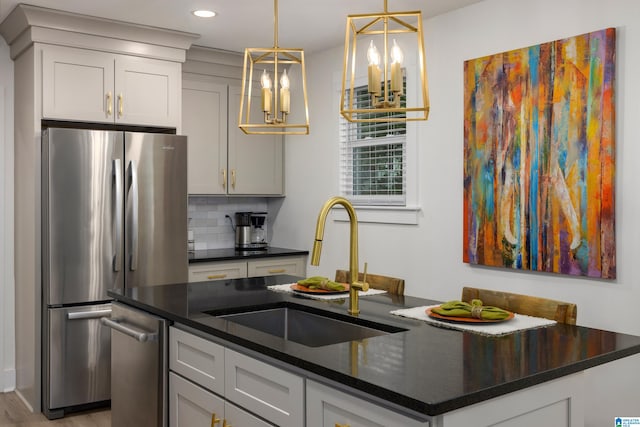 kitchen with stainless steel fridge, sink, a kitchen island with sink, light hardwood / wood-style flooring, and decorative backsplash