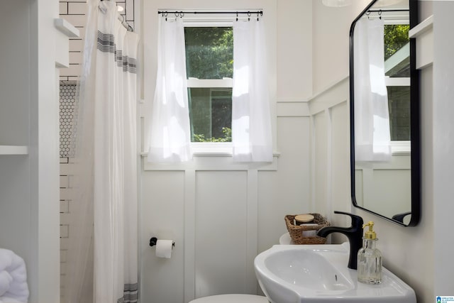 bathroom with plenty of natural light, sink, and toilet