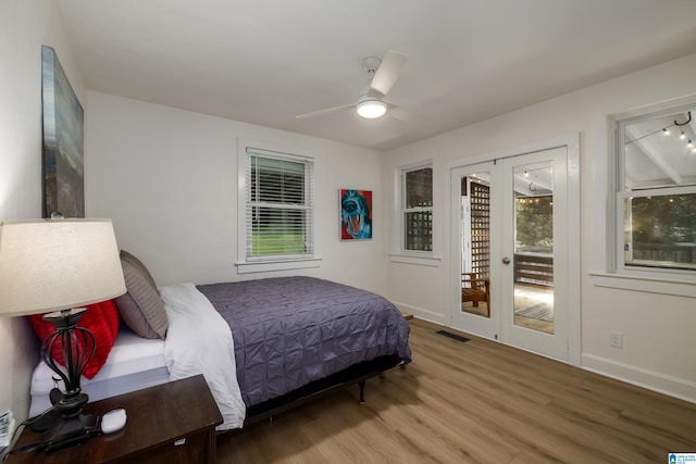 bedroom featuring access to exterior, hardwood / wood-style flooring, and ceiling fan