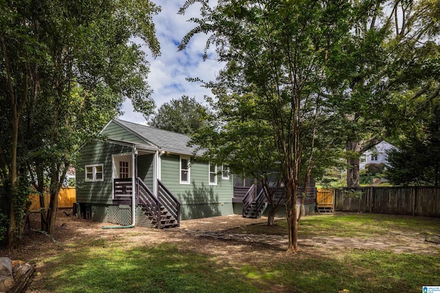 rear view of house featuring a yard