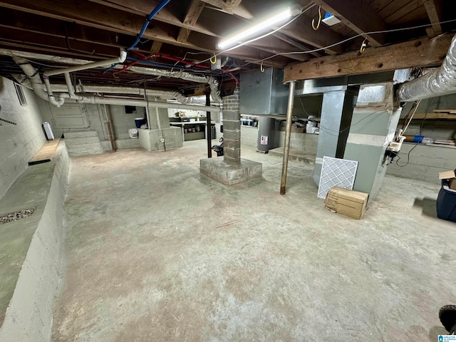 basement with water heater and heating unit