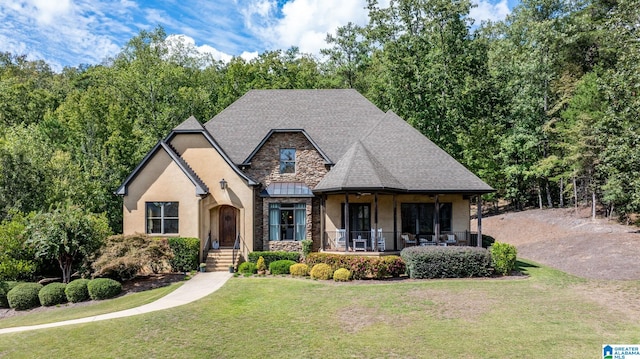 view of front of property featuring a front yard and covered porch