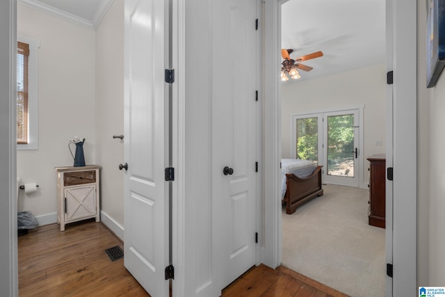 hall with crown molding and hardwood / wood-style floors