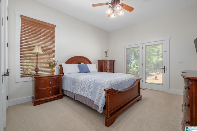 carpeted bedroom featuring ceiling fan and multiple windows