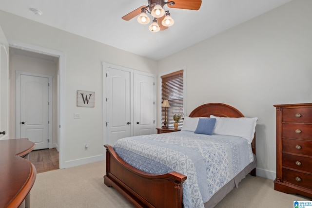 bedroom with light carpet, a closet, and ceiling fan