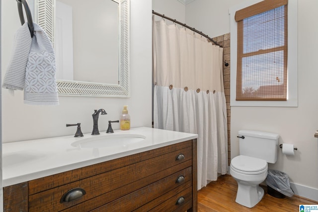 bathroom featuring hardwood / wood-style flooring, vanity, and toilet