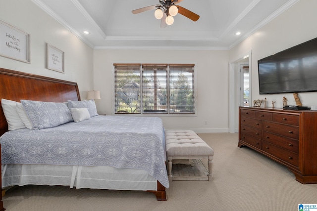 carpeted bedroom with ceiling fan, a raised ceiling, and multiple windows