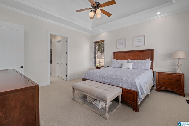 bedroom featuring ceiling fan, a raised ceiling, light carpet, and ornamental molding