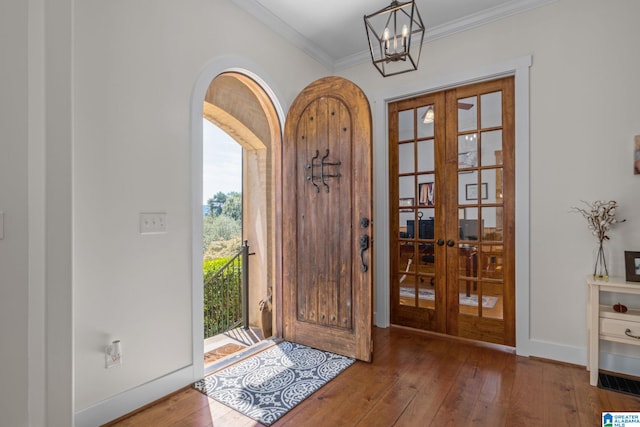 foyer entrance featuring wood-type flooring, french doors, and crown molding