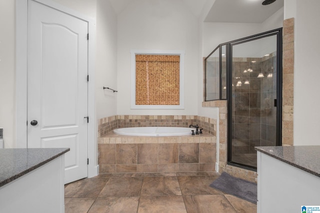 bathroom featuring plus walk in shower and vanity