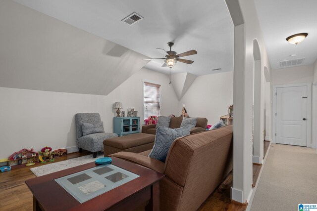 living room featuring ceiling fan, hardwood / wood-style flooring, and lofted ceiling