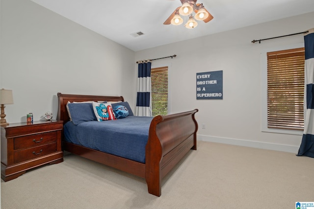 bedroom featuring light carpet and ceiling fan