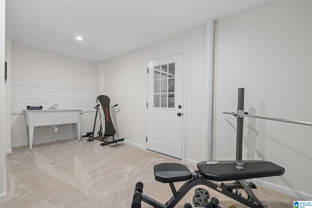 exercise room featuring light colored carpet