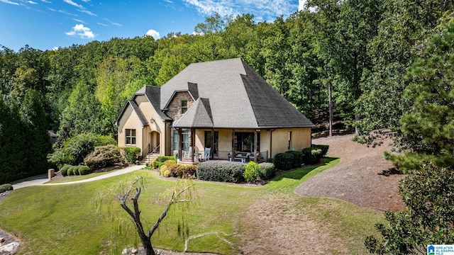 view of front of property with a front yard and covered porch