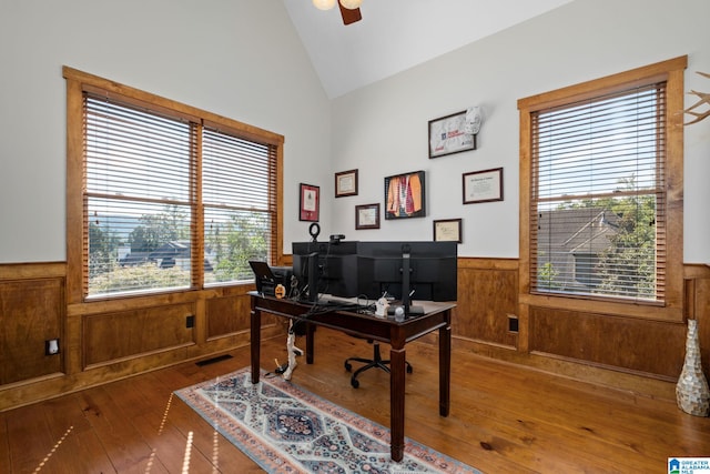 office area featuring ceiling fan, hardwood / wood-style flooring, vaulted ceiling, and a healthy amount of sunlight