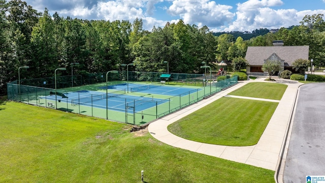 view of sport court with a lawn