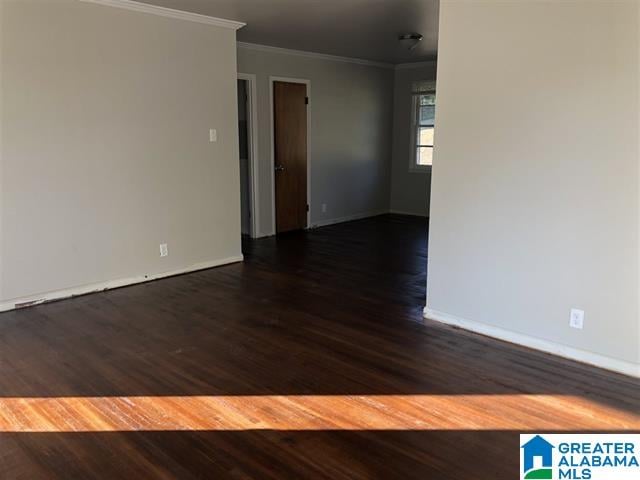 unfurnished room featuring dark hardwood / wood-style floors and ornamental molding