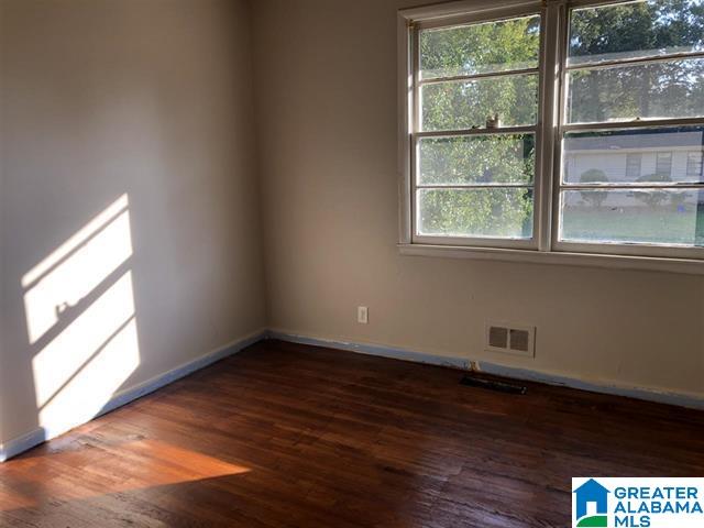 empty room with dark wood-type flooring