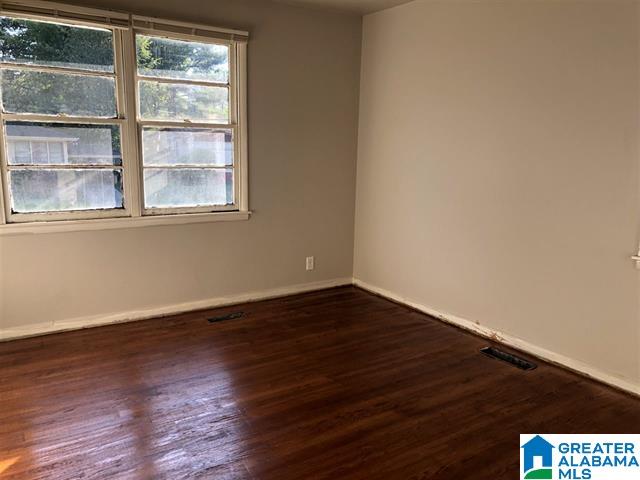 empty room with dark hardwood / wood-style floors