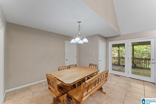 tiled dining room with lofted ceiling, a notable chandelier, and a textured ceiling