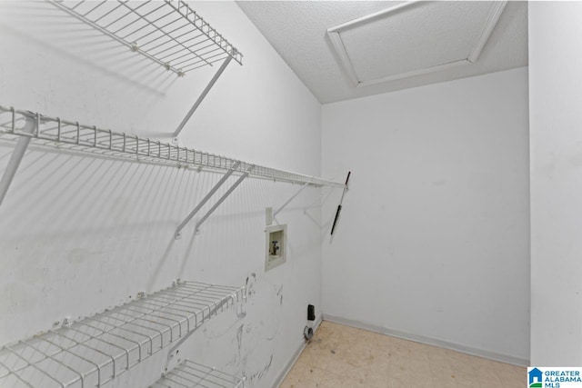 clothes washing area with washer hookup and a textured ceiling