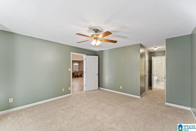 carpeted spare room with ceiling fan and a textured ceiling