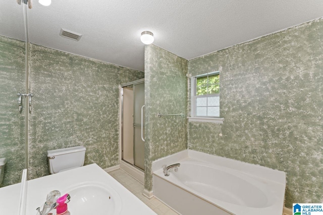 bathroom with independent shower and bath, a textured ceiling, and toilet