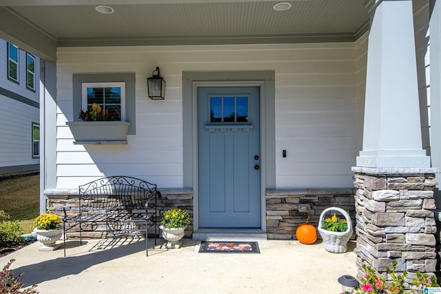 view of exterior entry with covered porch