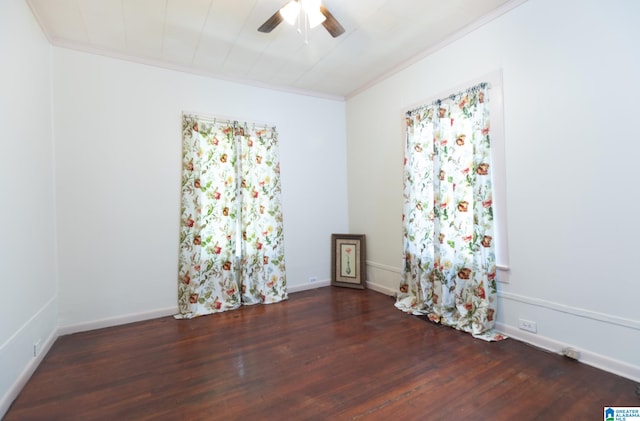 empty room featuring crown molding, ceiling fan, and dark wood-type flooring