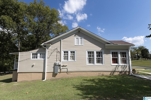 view of side of home featuring a yard