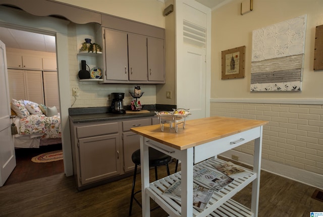 kitchen featuring gray cabinets, dark hardwood / wood-style flooring, and wood counters