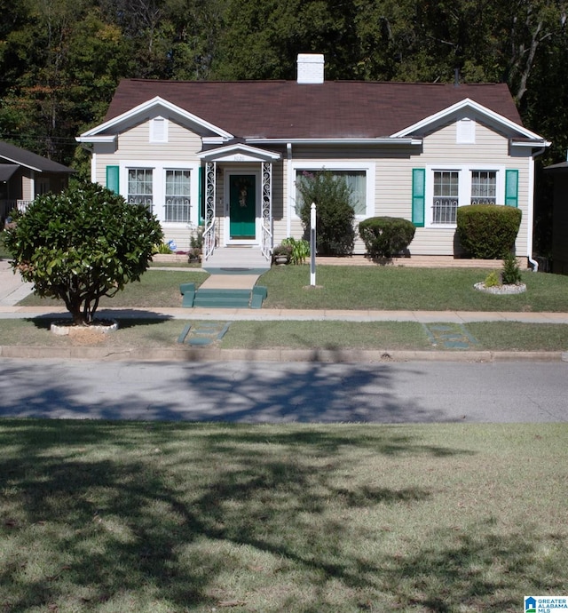 ranch-style home with a front lawn