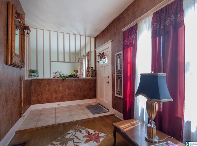 foyer featuring hardwood / wood-style flooring and a healthy amount of sunlight