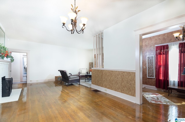 interior space featuring a fireplace, an inviting chandelier, and hardwood / wood-style flooring