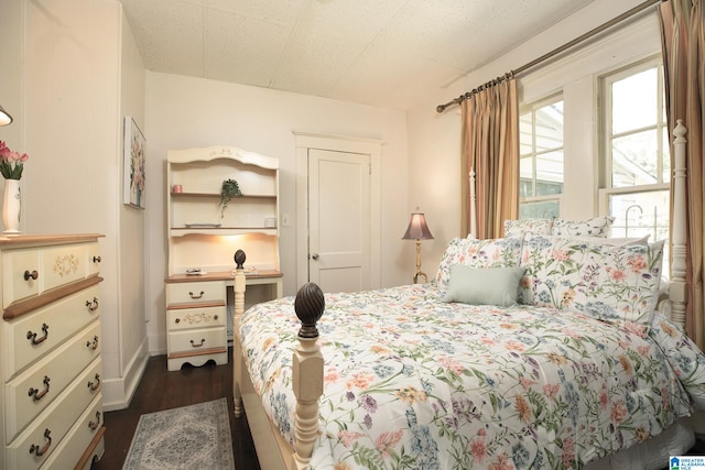 bedroom with dark hardwood / wood-style floors