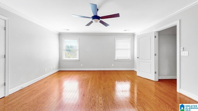 empty room featuring wood-type flooring, crown molding, and ceiling fan