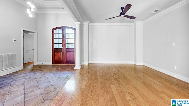 foyer with ceiling fan, ornate columns, crown molding, light hardwood / wood-style flooring, and french doors