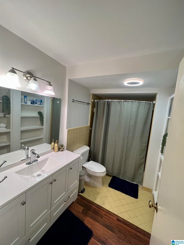 bathroom featuring vanity, a shower with curtain, wood-type flooring, and toilet