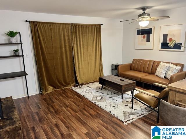 living room with ceiling fan and hardwood / wood-style floors