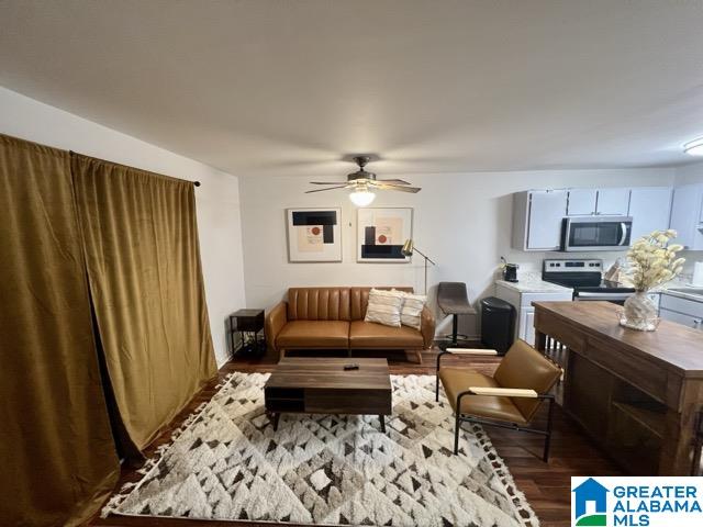 living room featuring ceiling fan and hardwood / wood-style floors