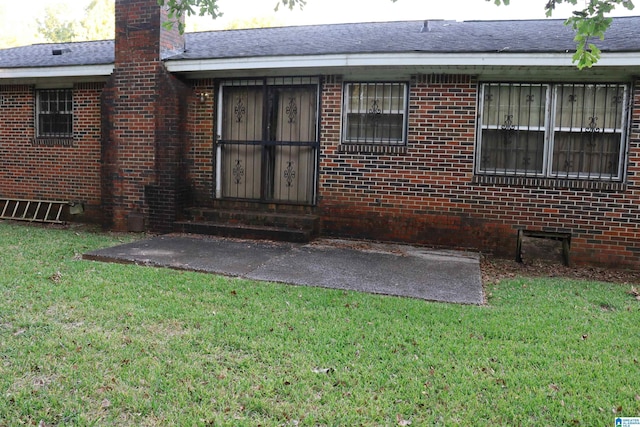 rear view of house with a lawn