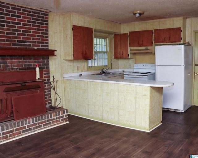 kitchen with dark hardwood / wood-style floors, sink, kitchen peninsula, and white appliances