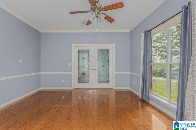 spare room with hardwood / wood-style floors, ceiling fan, french doors, and ornamental molding