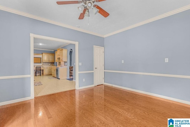 unfurnished room featuring ceiling fan, light hardwood / wood-style flooring, and ornamental molding