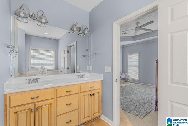 bathroom with ceiling fan and vanity