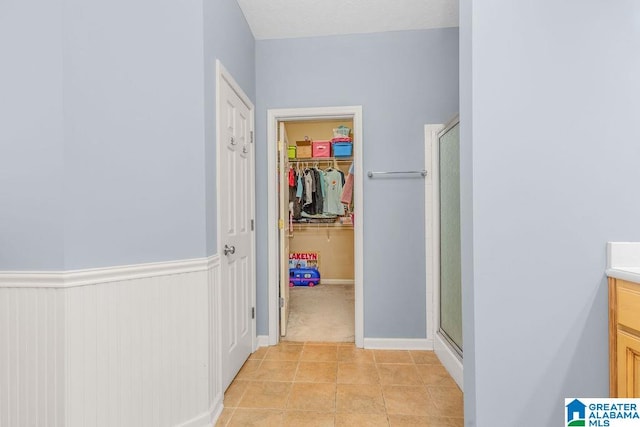 bathroom with an enclosed shower, tile patterned floors, and vanity