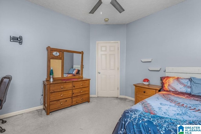 carpeted bedroom featuring a textured ceiling and ceiling fan